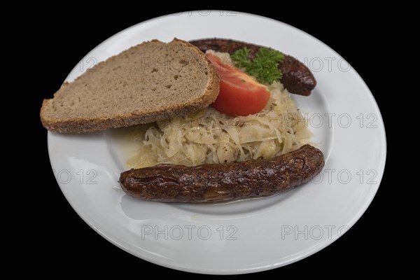 Bratwurst with sauerkraut and bread on a black background