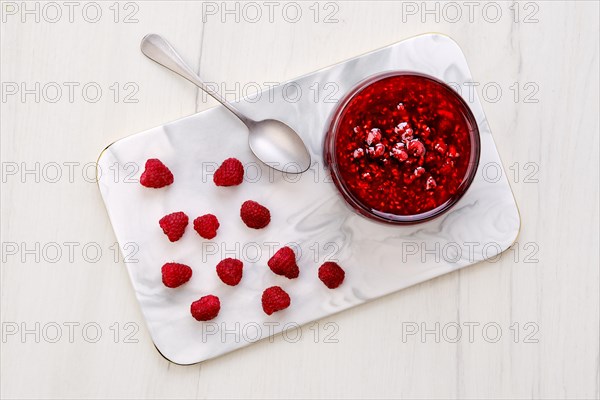 Top view of transparent pot with raspberry jam