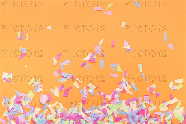 Colorful confetti orange background