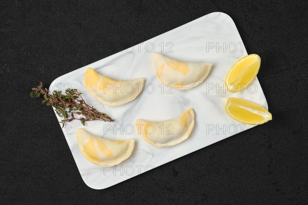 Semifinished frozen salmon dumplings on serving board