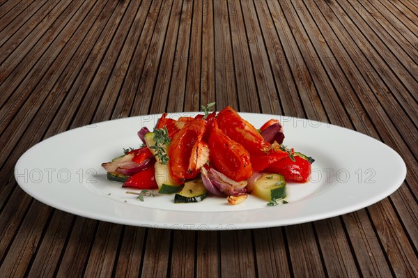 Grilled vegetables on white plate cutted on slices