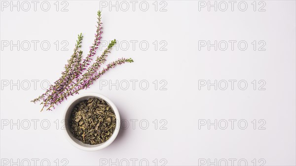 Elevated view lavender flowers near dry petals bowl white surface