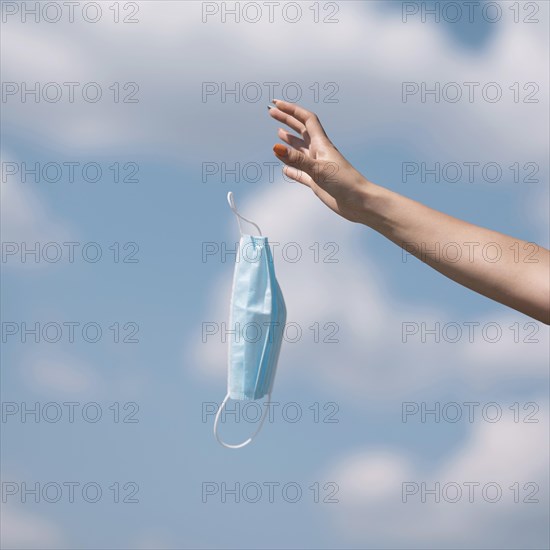 Girl throwing out medical mask