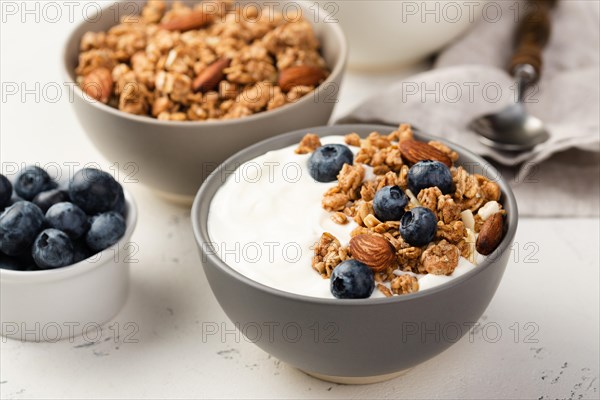 High angle bowls breakfast cereal with blueberries yogurt