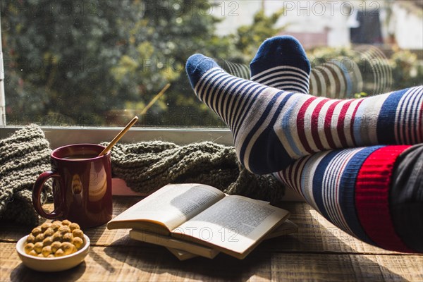 Legs striped socks near window