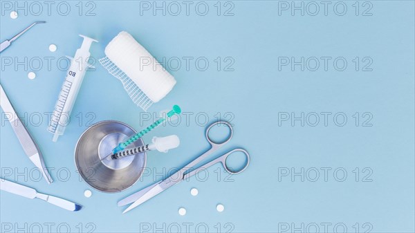 Surgical equipment s syringe glass pills gauze roll blue background. Resolution and high quality beautiful photo