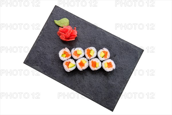 Rolls with salmon and avocado on slate plate isolated on white