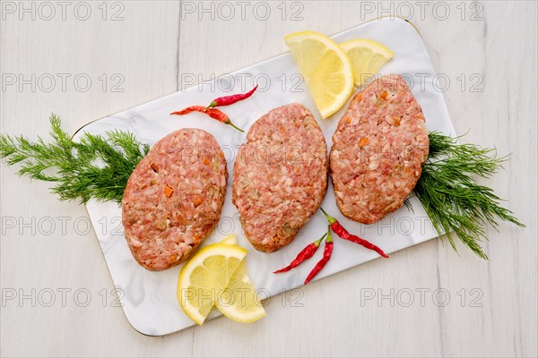 Uncooked cutlet with minced beef meat and cabbage ready for cooking