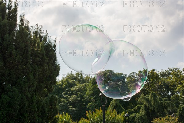 Blown soap bubbles float in air in view