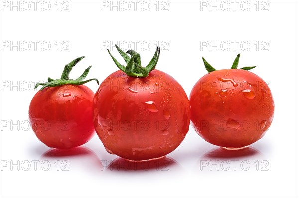 Fresh wet tomato cherry isolated on white background