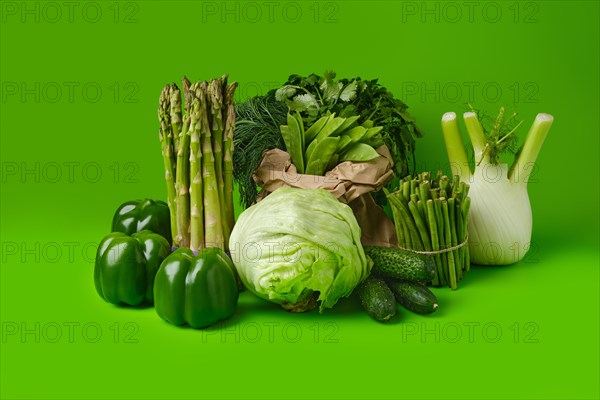 Various fresh green vegetables on wooden background