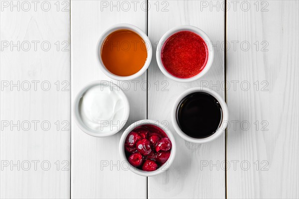 Assortment of different sauce on white wooden table