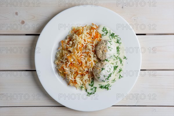 Top view of plate with meatballs with rice and carrot