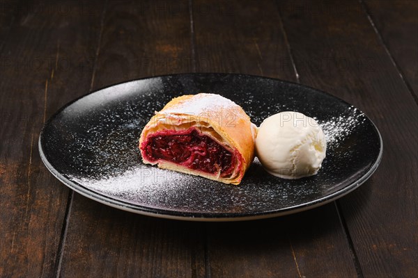 Piece of classic cherry strudel on a plate