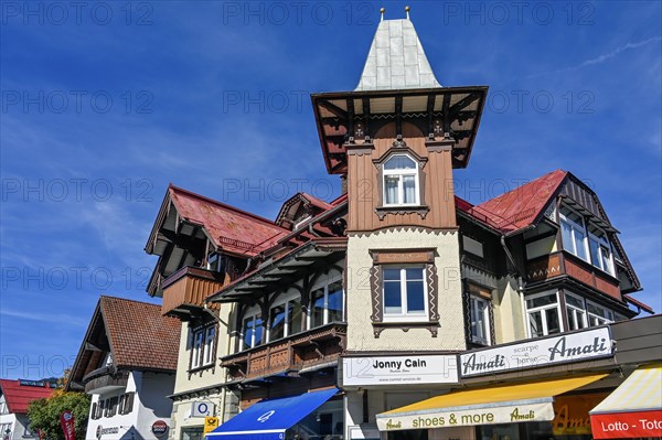 Pedestrian zone with classic wooden building with wooden shingle facade