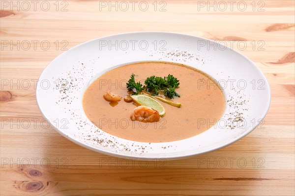 Shrimp soup on wooden table