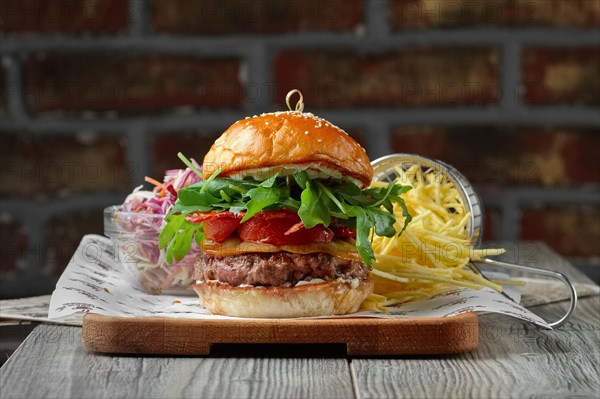 Burger on the wooden table with cheese