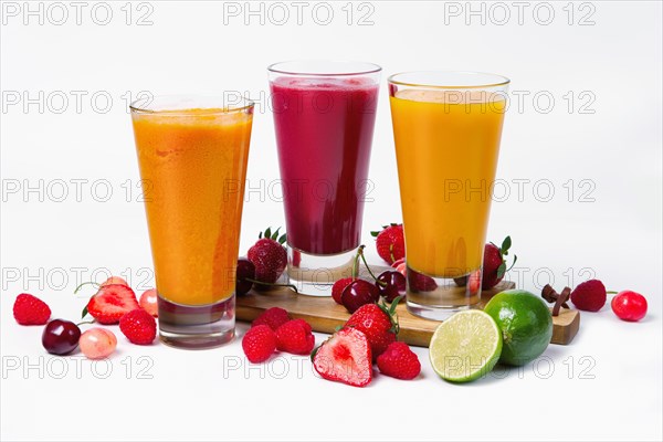 Three glasses with fruit smoothies on white background