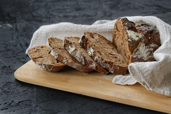 Artisan freshly baked broun bread with raisins cut on slices