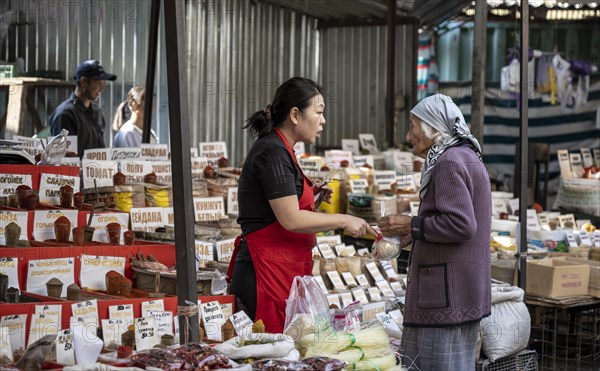 Old woman bargaining with a vendor