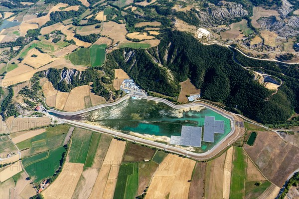 Aerial photo photovoltaics on a water retention basin in the French Alps near Lazer