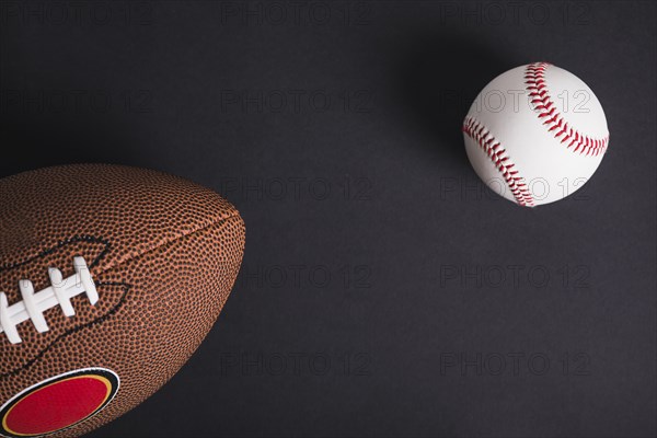 Brown rugby ball baseball black background