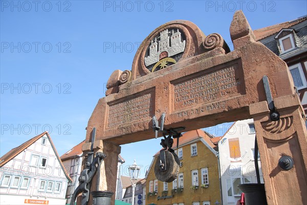 Detail of the draw well with town coat of arms