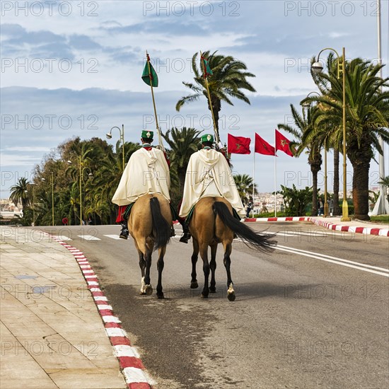 Two mounted guards in traditional dress on the street