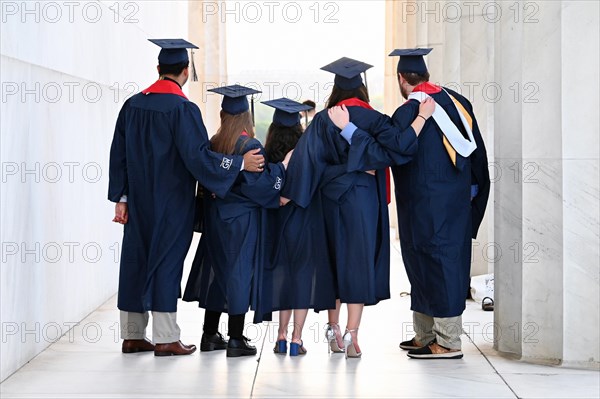 College students celebrate their graduation at the Lincoln Memorial on the National Mall