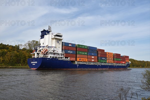 Container ship Sonderborg in autumn in the Kiel Canal