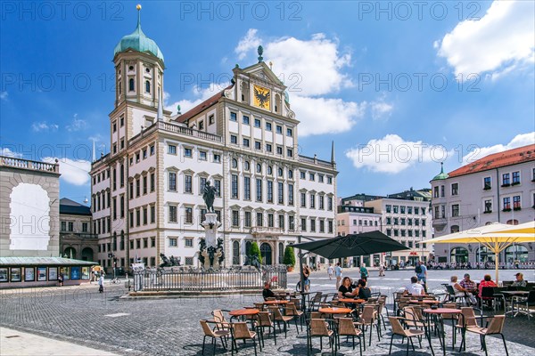 Restaurant terrace on the town hall square with town hall