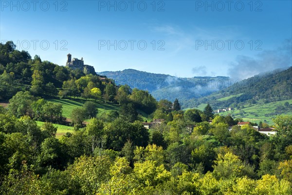 Saint-Ilpize castle perched on a volcanic peak above river Allier. Haute-Loire department. Auvergne-Rhone-Alpes. France