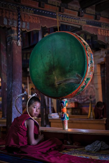 A young monk with a drum