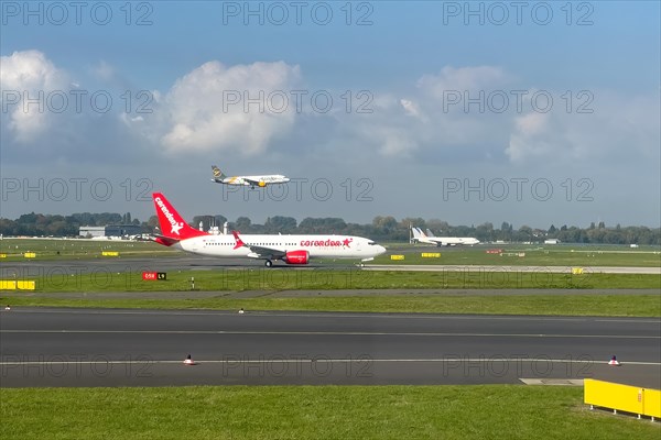 Two aircraft passenger jets jets jets jets in front Corendon Airlines in the back Condor on parallel runway runway during simultaneous takeoff takeoff and landing touchdown at Duesseldorf International Airport