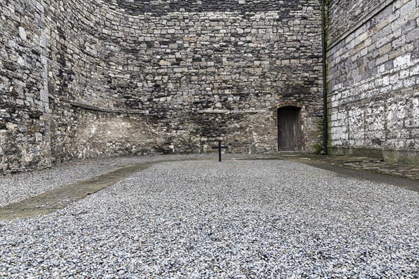 Cross in courtyard marks execution site