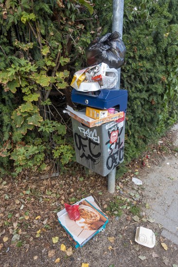 Overfilled public waste bin