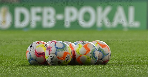 Adidas Derbystar match balls in front of perimeter advertising DFB Cup