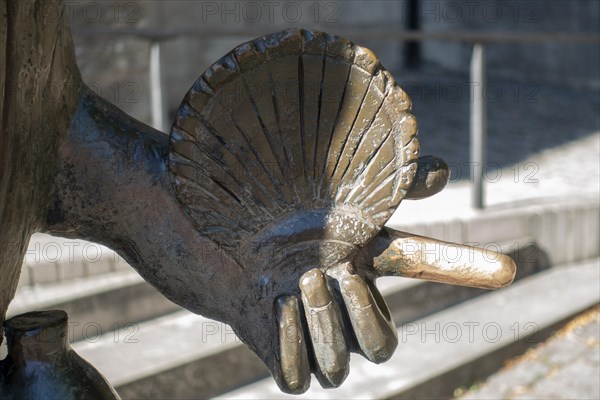 Pilgrim statue with a scallop shell in front of the Protestant Church of St. James on the Way of St. James to Santiago de Compostella