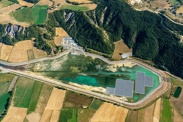 Aerial photo photovoltaics on a water retention basin in the French Alps near Lazer