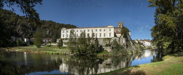 Lavoute Chilhac labelled Les Plus Beaux Villages de FrancePriory Sainte-Croix reflecting in the river Allier