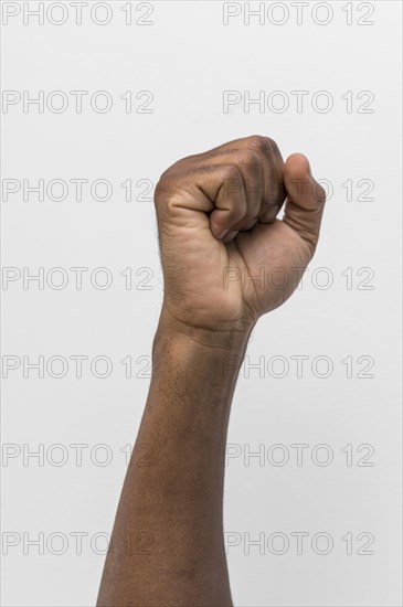 Black person holding fist up