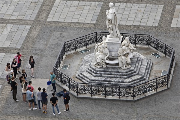 Teacher with group of pupils in front of the Schiller Monument on the Gendarmenmarkt