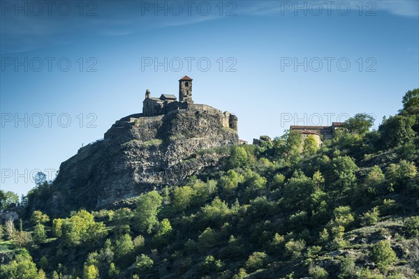 Saint-Ilpize castle perched on a volcanic peak above river Allier. Haute-Loire department. Auvergne-Rhone-Alpes. France