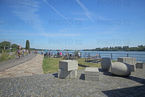 Rest area for cyclists at the wine loading crane on the banks of the Rhine