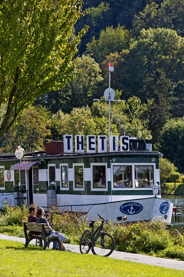 Bicycle rider at the restaurant ship Thetis