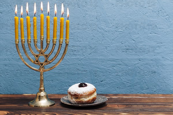 Jewish menorah with tasty donut