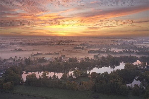 Aerial view of the landscape around Sandbraak Lake near Fuenfhausen in Hamburg's Kirchwerder district in autumnal morning atmosphere with light ground fog. In the background the nature reserve Kirchwerder Wiesen. Fuenfhausen