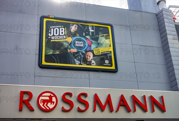 Large poster advertising the Bundeswehr on the wall of a Rossmann shop