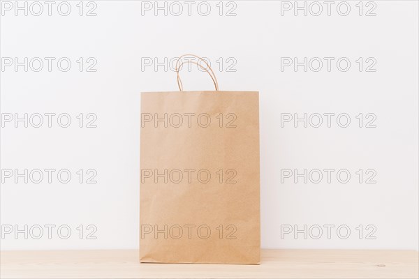 Brown shopping bag wooden surface