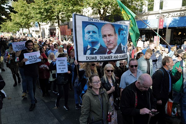 Protestors at a Cost of Living Crisis demonstration in Dublin city centre carrying a banner condemning the Irish Taoiseach Micheal Martin and other government politicians Leo Varadkar and Eamon Ryan. Dublin